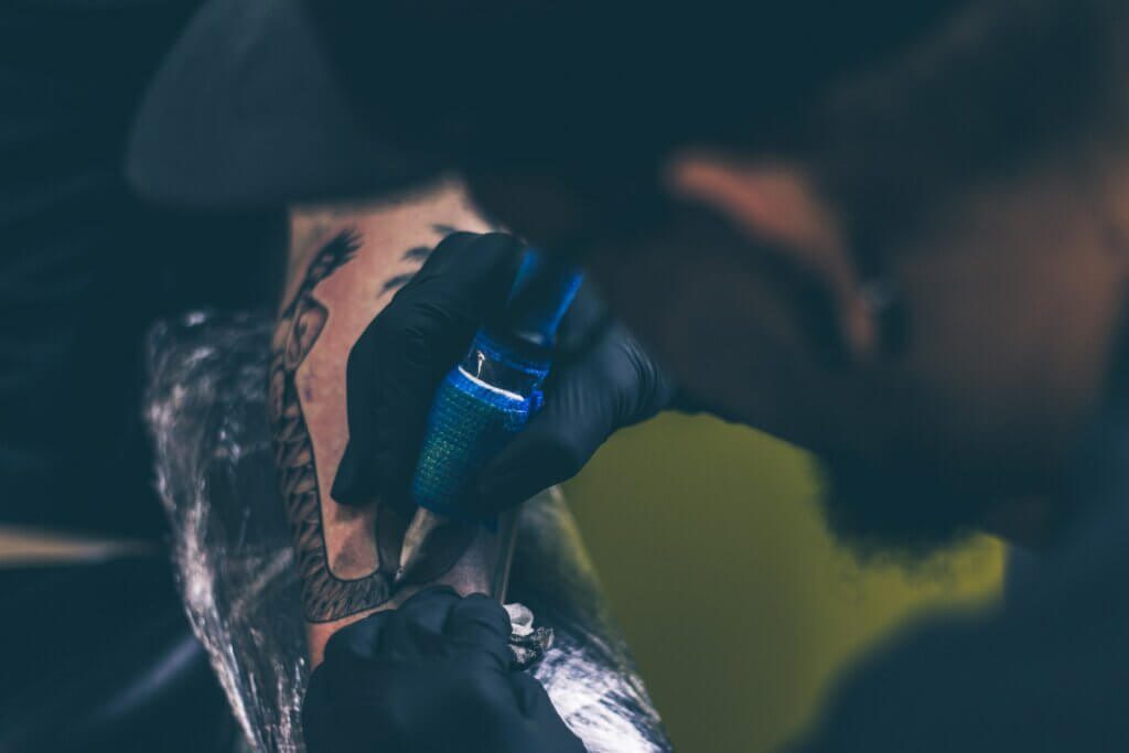 tattoo artist giving a tattoo